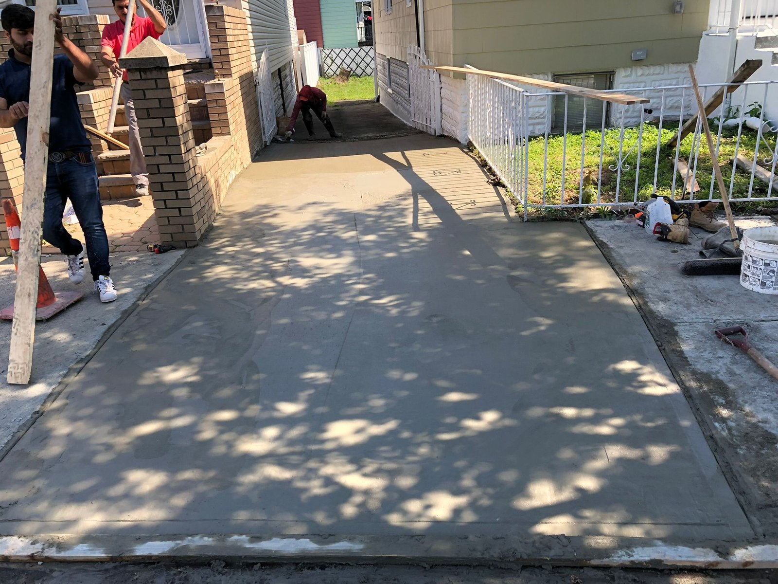 Workers performing concrete construction services such as driveways, patios, sidewalks, slabs, foundations, steps, leveling, repairs, and sealing in Yonkers, NY.