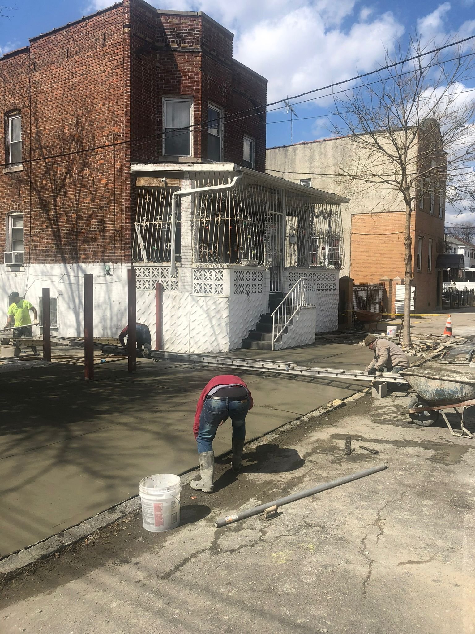 Workers performing concrete construction services such as driveways, patios, sidewalks, slabs, foundations, steps, repairs, and leveling in Queens, NY.