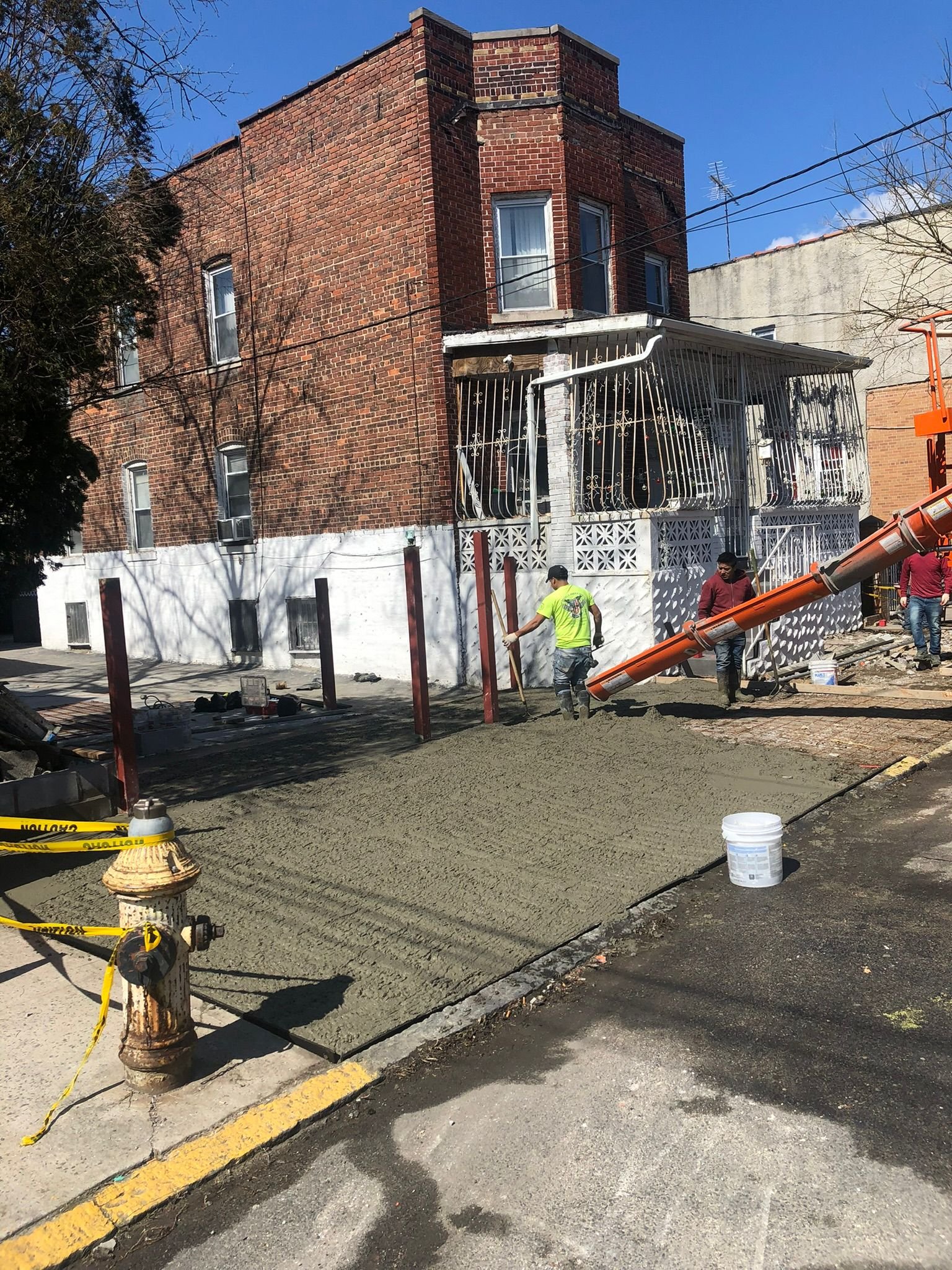 Concrete slab being poured and smoothed for a home or garage project in the Bronx.