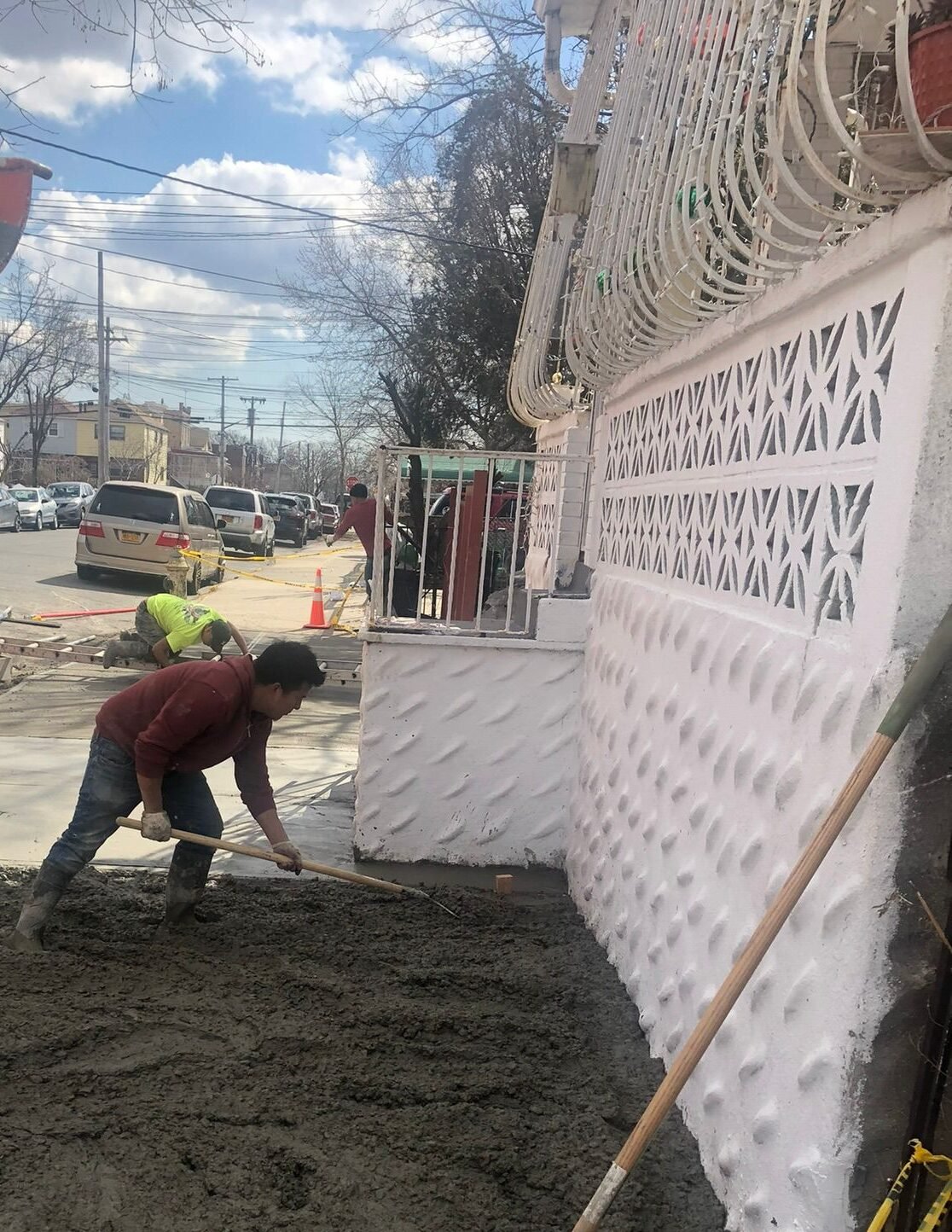 Workers performing concrete construction services such as driveways, patios, sidewalks, slabs, foundations, repairs, and leveling in New Rochelle, NY.