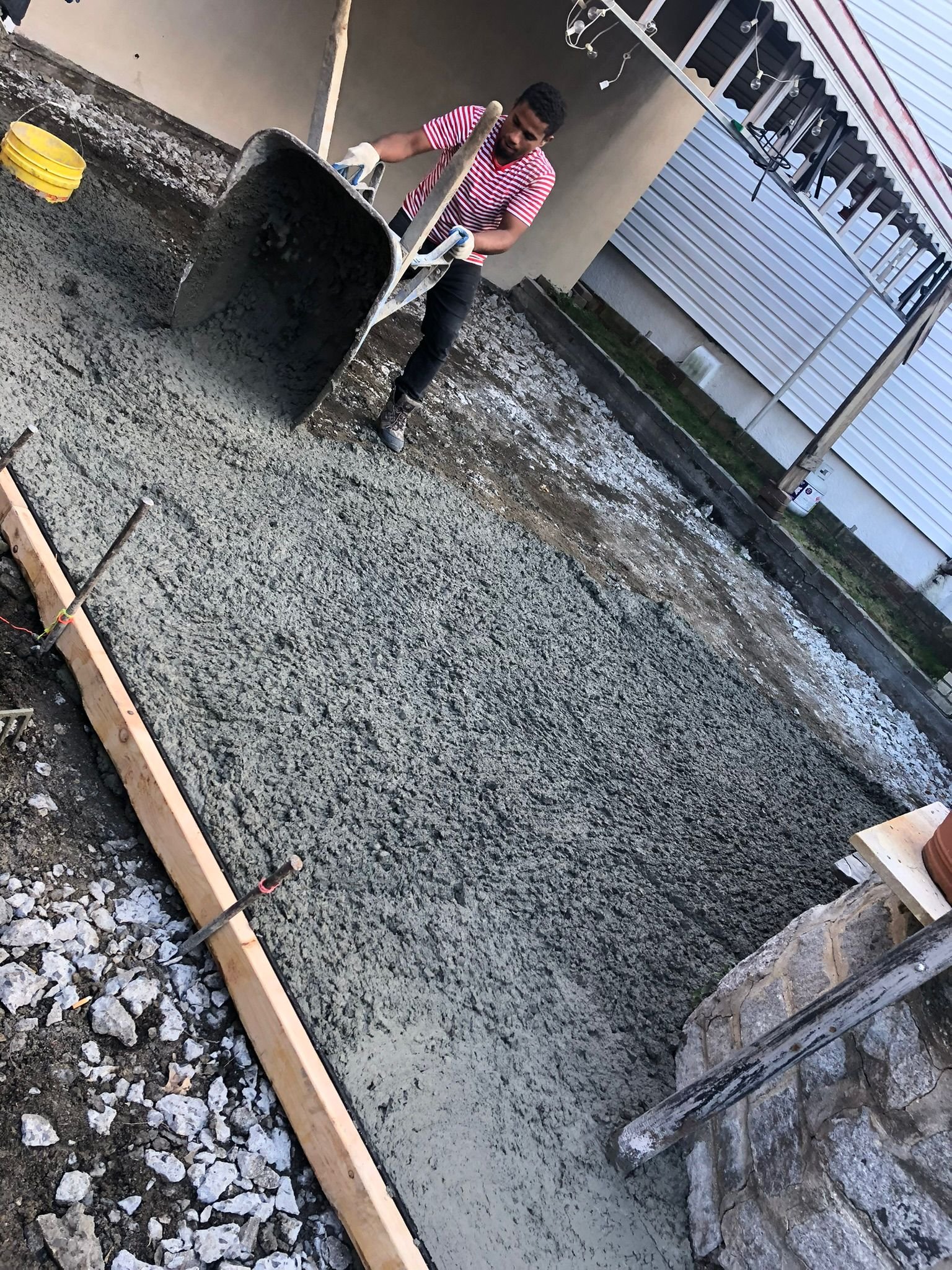 Workers performing concrete construction services such as driveways, patios, sidewalks, slabs, foundations, steps, leveling, repairs, and sealing in White Plains, NY.