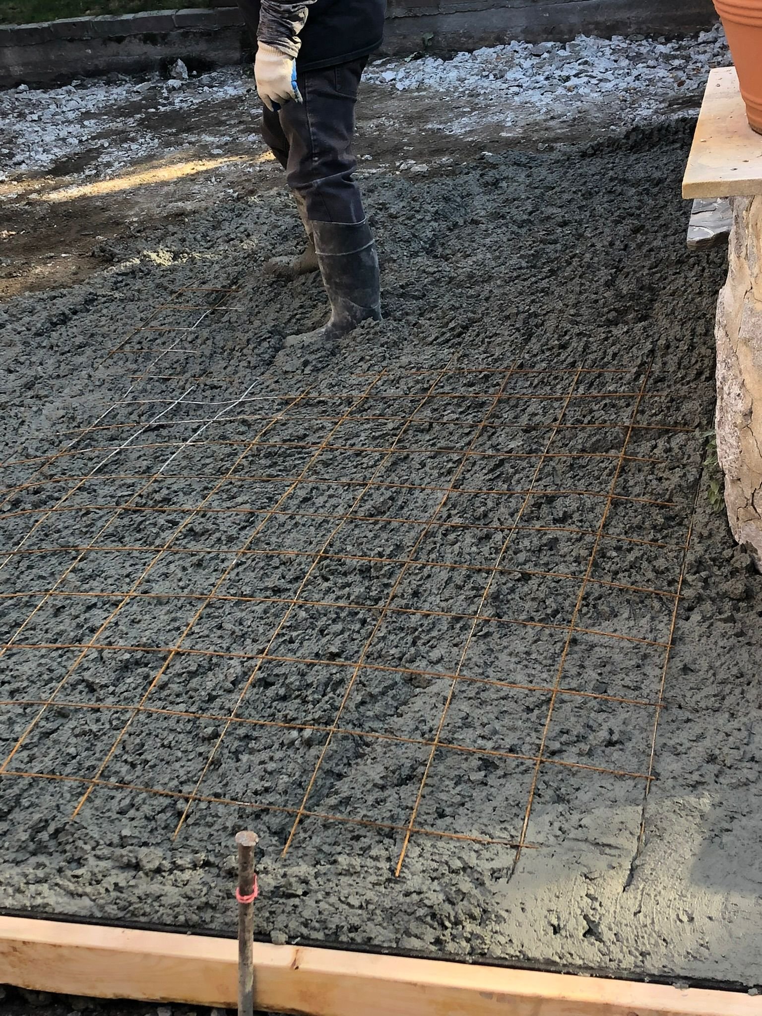 Concrete foundation walls and footings being built on a residential construction site.