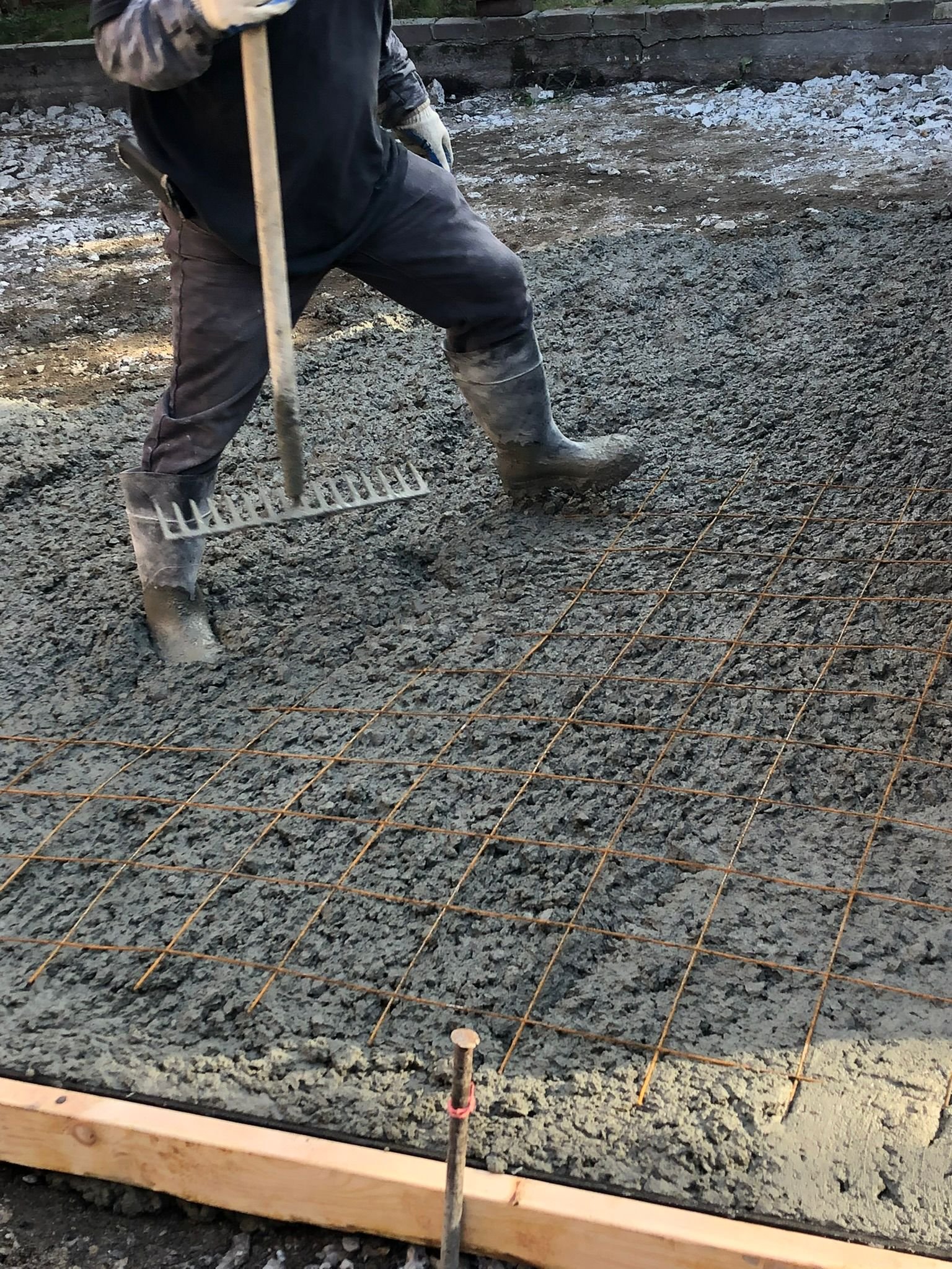 Concrete foundation walls and slab being built on a Brooklyn construction site.