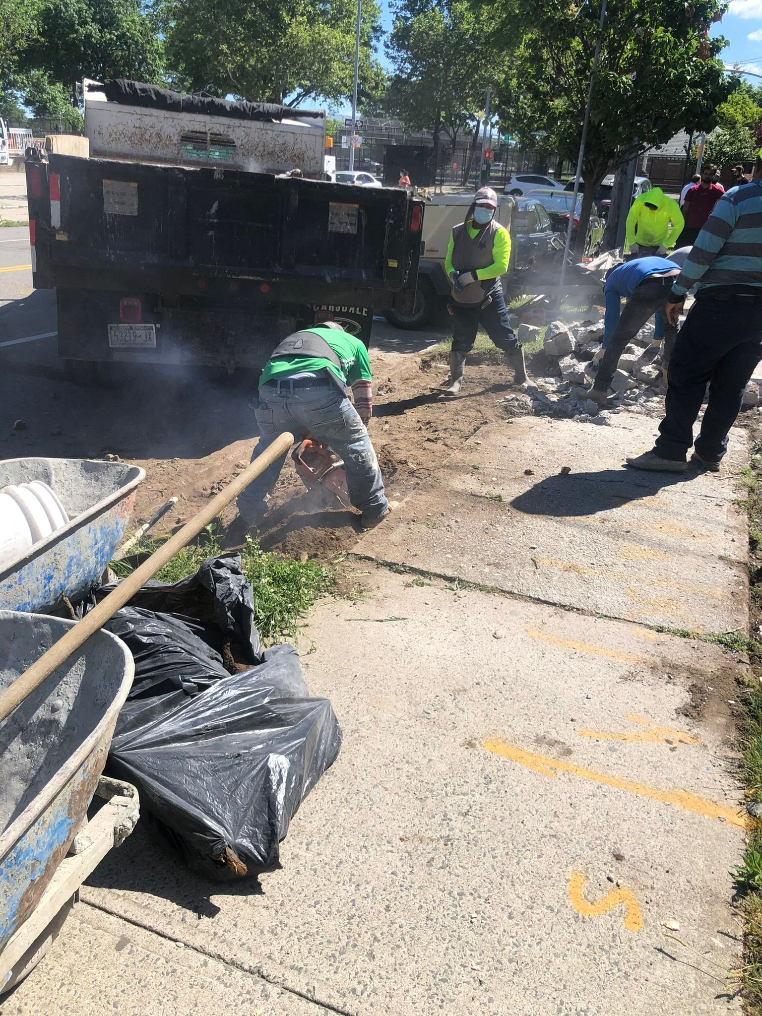 Workers installing, repairing, or finishing concrete surfaces on residential and commercial properties in New York City.