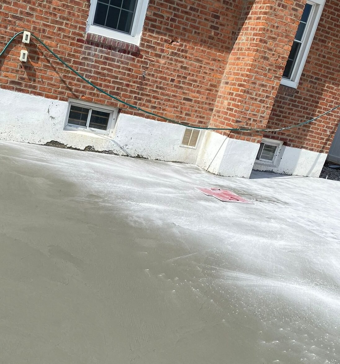 Construction crew working on various concrete projects—driveways, patios, sidewalks, foundations, steps, slabs, and repairs—at residential and commercial sites in Mount Vernon, NY.