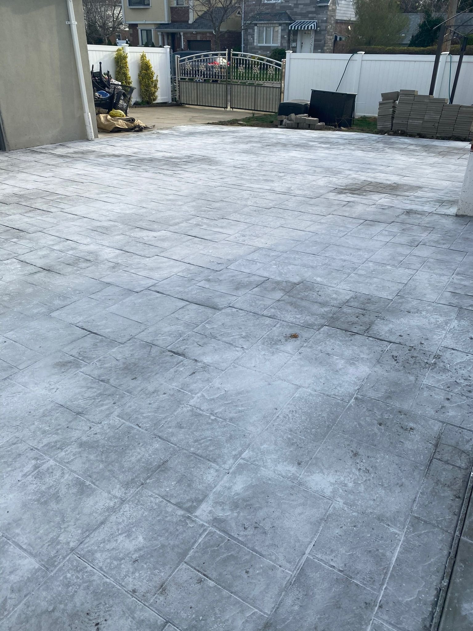 Workers installing, repairing, or finishing concrete surfaces on residential and commercial properties in New York City.
