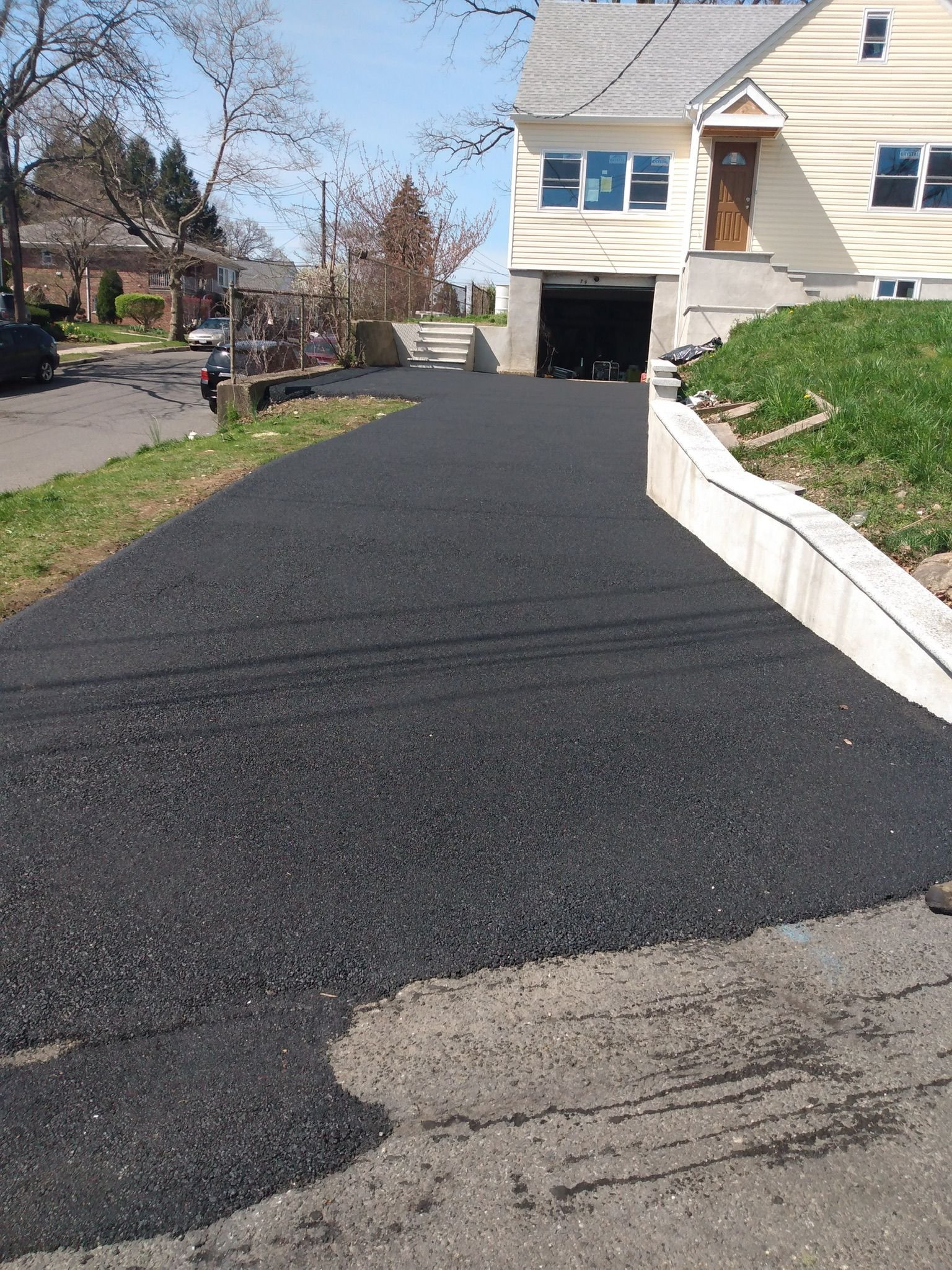 Workers installing, repairing, or finishing concrete surfaces on residential and commercial properties in New York City.