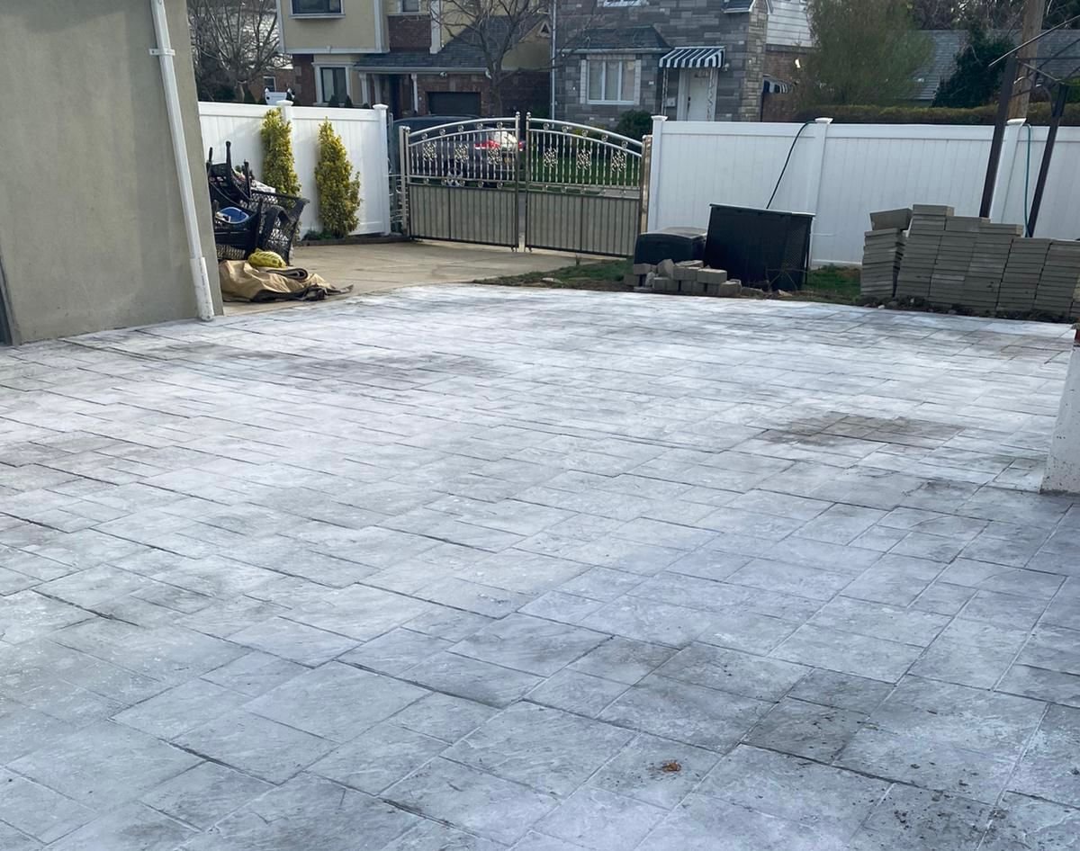 Construction crew working on various concrete projects—driveways, patios, sidewalks, foundations, steps, slabs, and repairs—at residential and commercial sites in Mount Vernon, NY.
