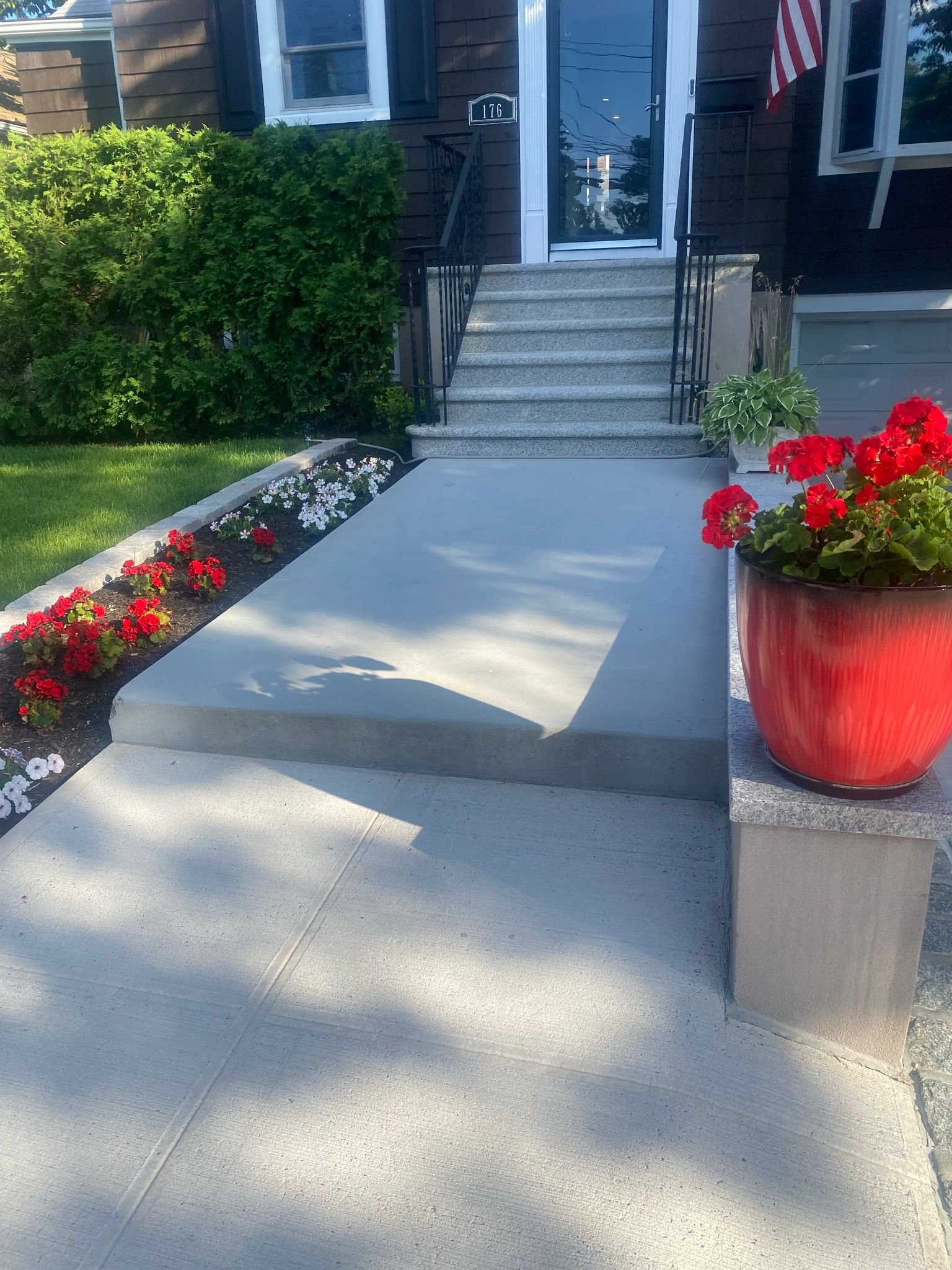 Workers performing concrete construction services such as driveways, patios, sidewalks, slabs, foundations, steps, repairs, and leveling in Queens, NY.