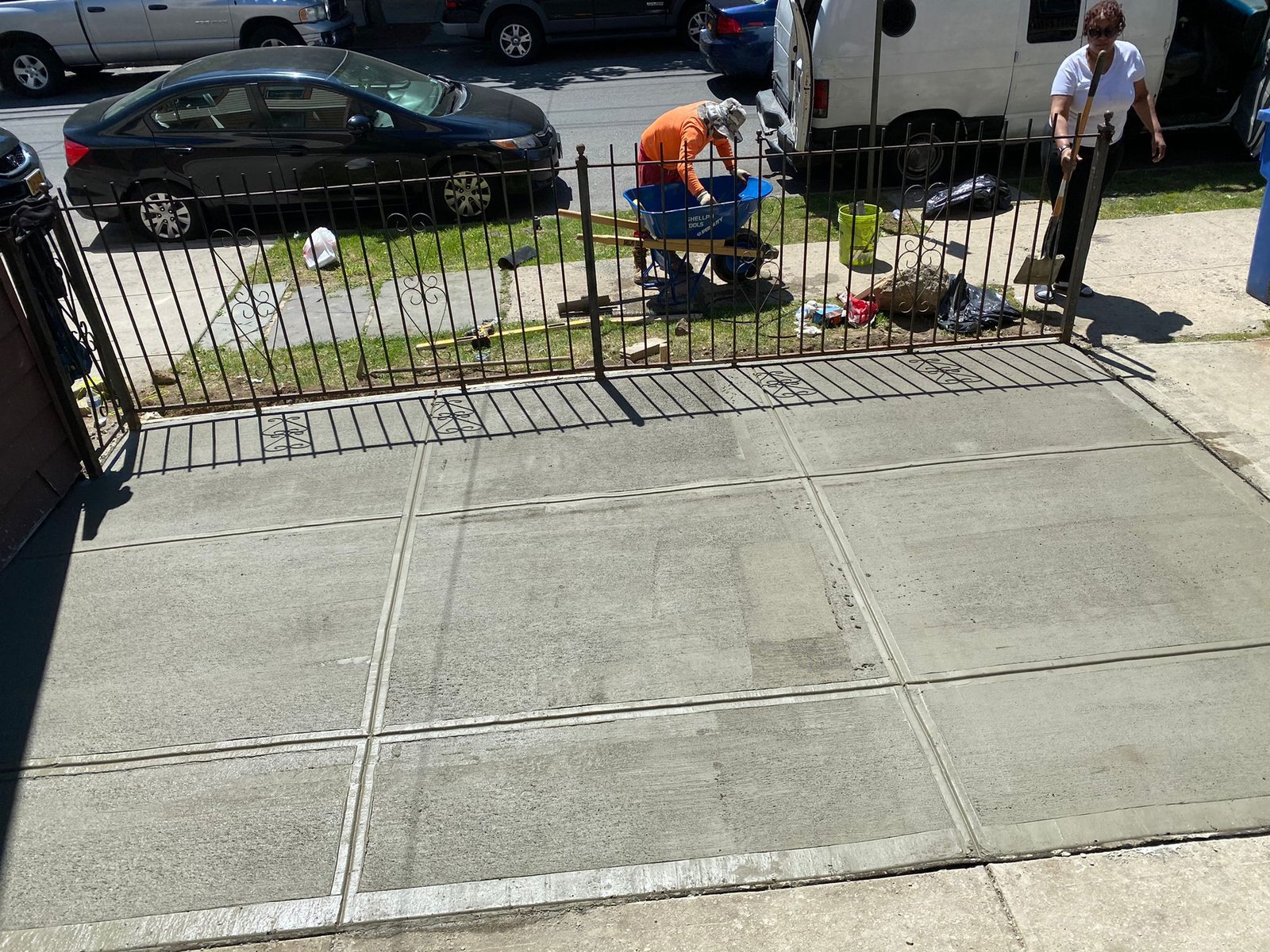 Workers installing, repairing, or finishing concrete surfaces on residential and commercial properties in New York City.