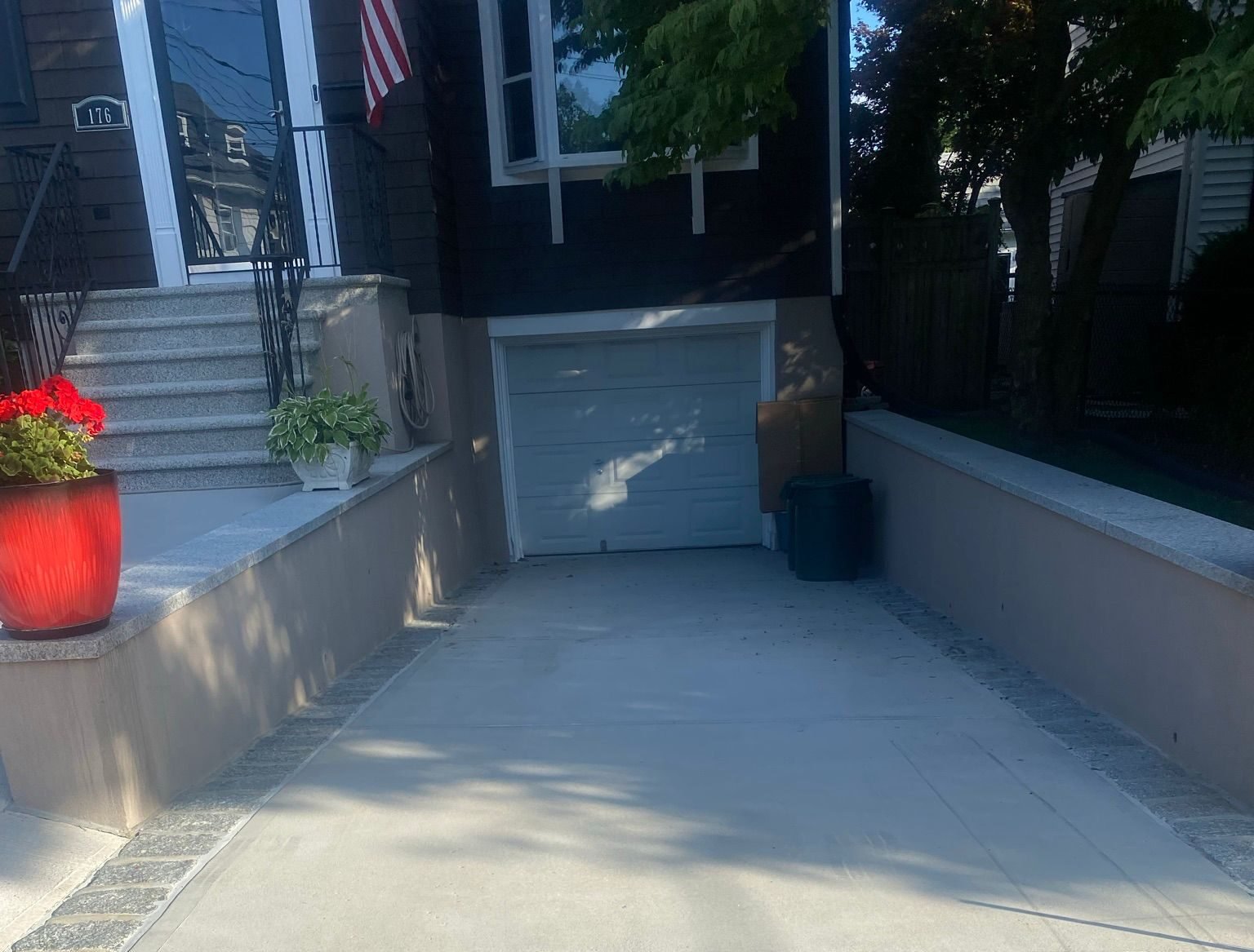 Workers installing, repairing, or finishing concrete surfaces on residential and commercial properties in New York City.