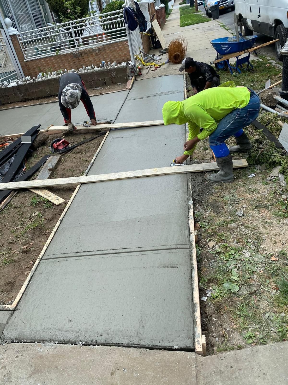 Construction crew working on various concrete projects—driveways, patios, sidewalks, foundations, steps, slabs, and repairs—at residential and commercial sites in Mount Vernon, NY.