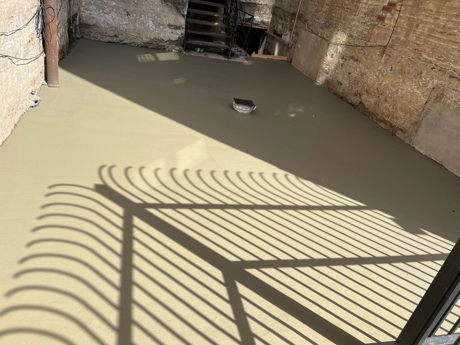 Workers performing concrete construction services such as driveways, patios, sidewalks, slabs, foundations, steps, repairs, and leveling in Queens, NY.