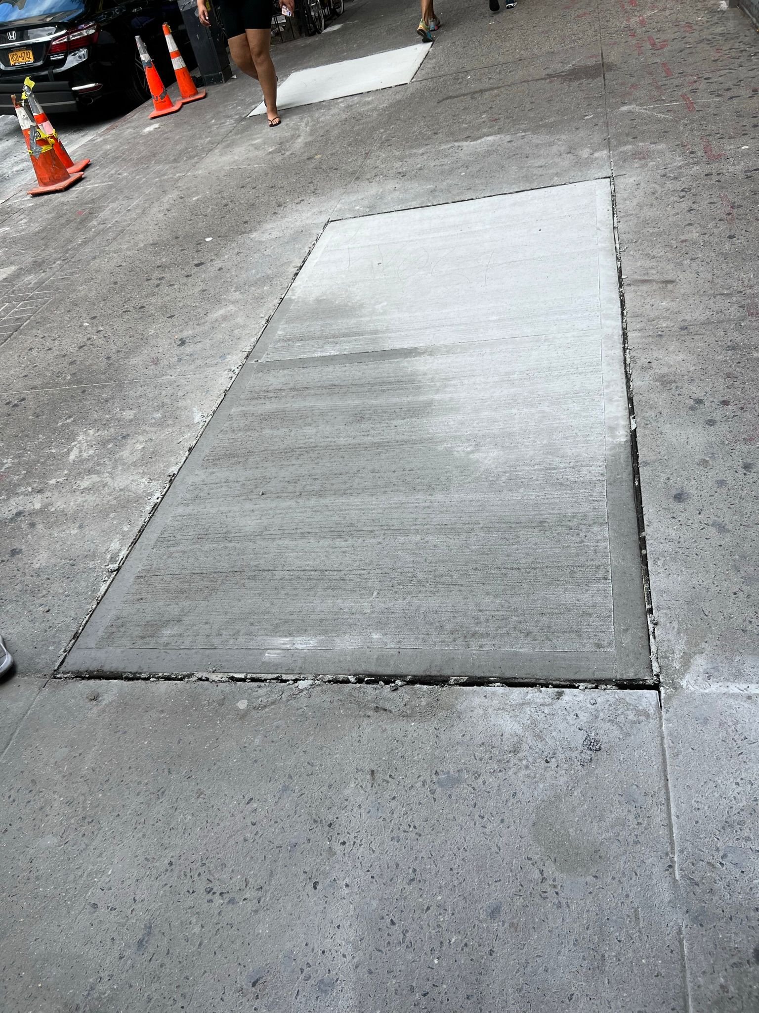 Workers performing concrete construction services such as driveways, patios, sidewalks, slabs, foundations, repairs, and leveling in New Rochelle, NY.