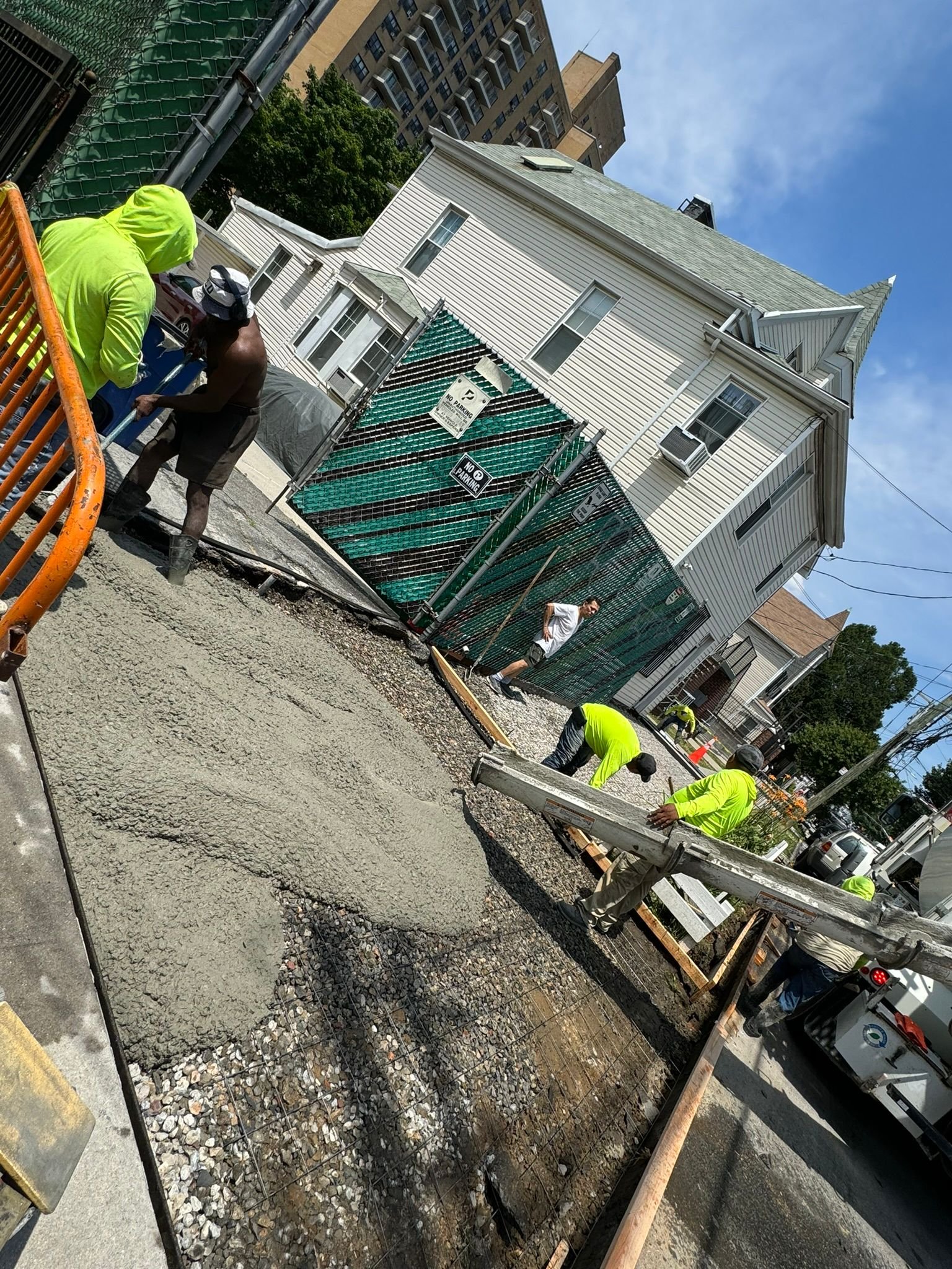 Workers performing concrete construction services such as driveways, patios, sidewalks, slabs, foundations, steps, repairs, and leveling in Queens, NY.