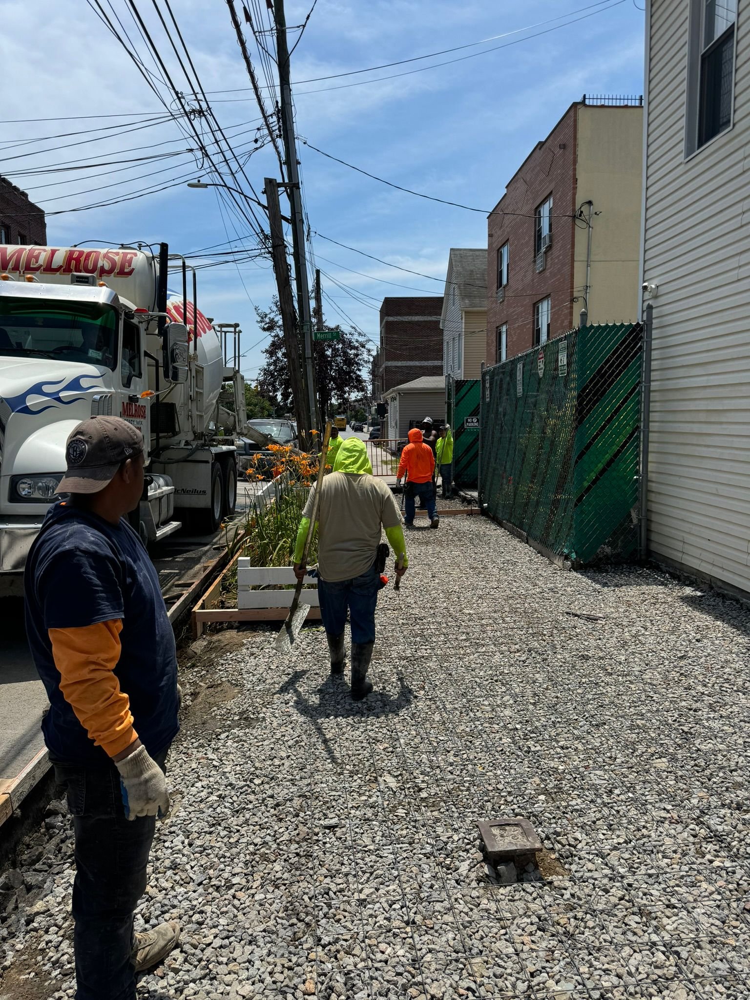 Workers performing concrete construction services such as driveways, patios, sidewalks, slabs, foundations, steps, repairs, and leveling in Queens, NY.