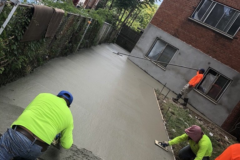NYC crew troweling a freshly poured concrete slab